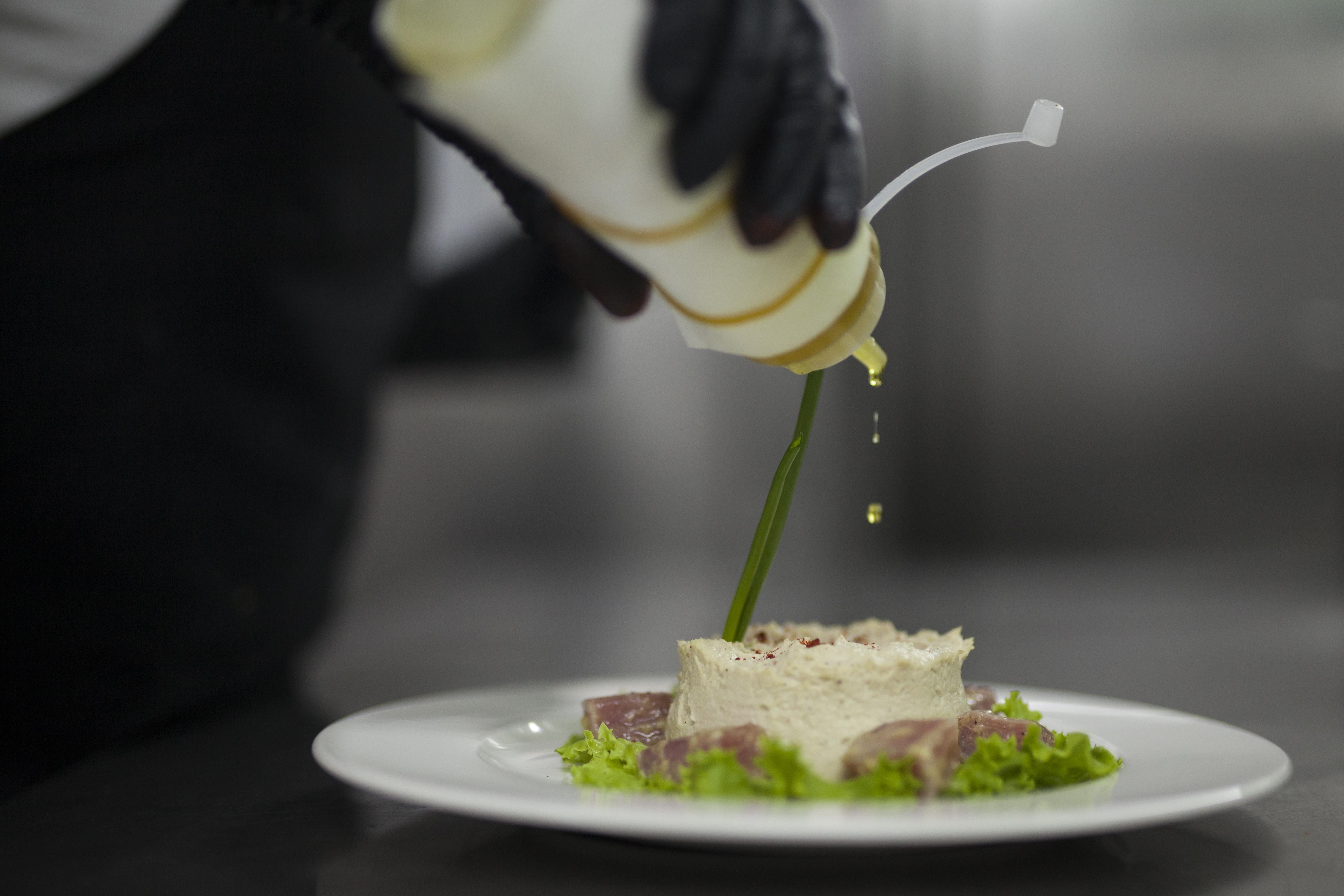 Grand Hotel Yerevan - Small Luxury Hotels Of The World Eksteriør billede A chef finishing a dish